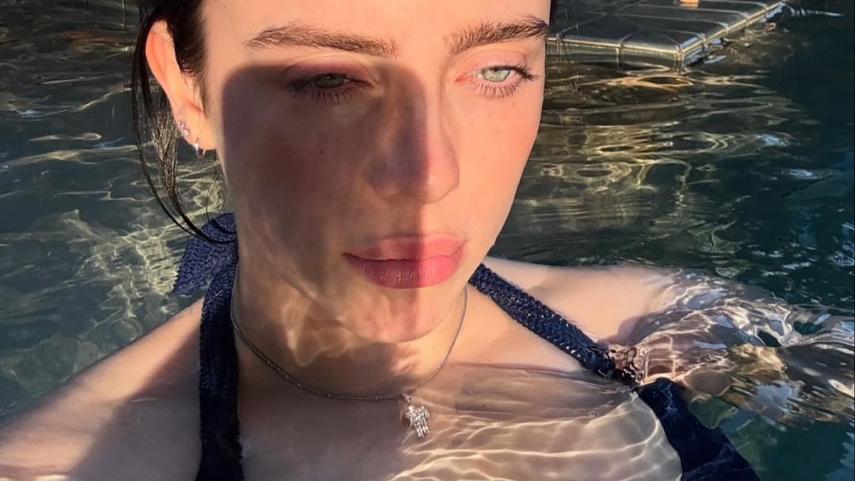 Billie Eilish in a navy bikini poolside selfie