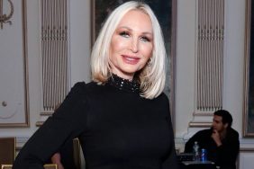 Kim DePaola posing in a black dress with her hand on her hip