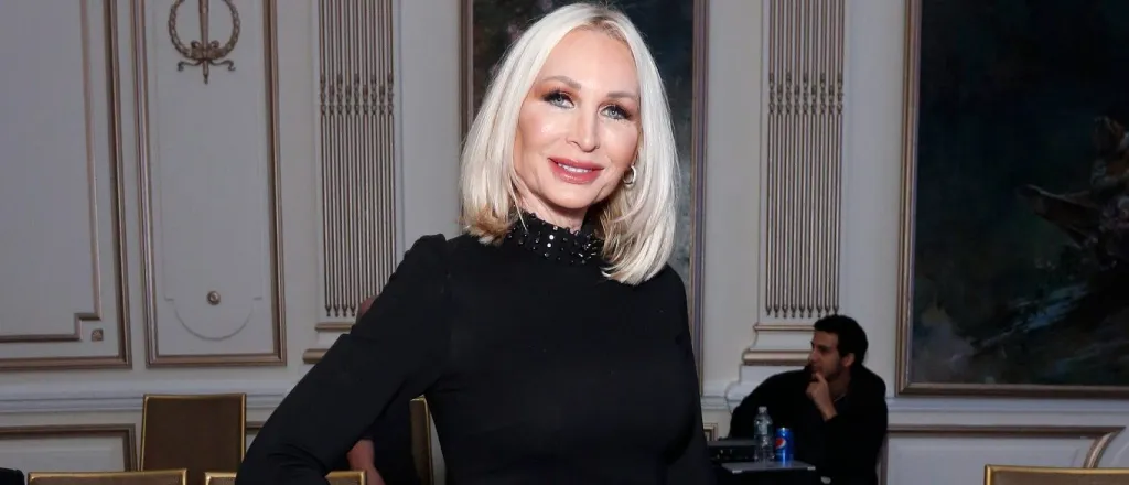 Kim DePaola posing in a black dress with her hand on her hip