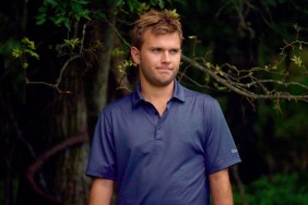 Chase Chrisley in a blue polo standing in front of a tree
