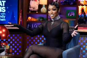 Porsha Williams in a black jump suit, holding her arms out while appearing as a guest on Watch What Happens Live