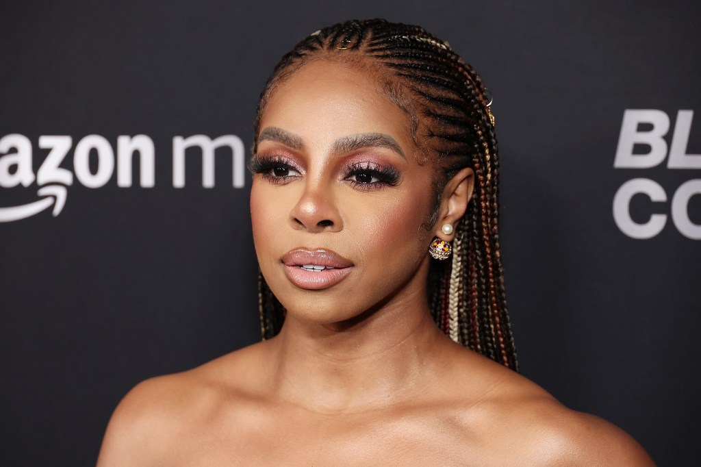 Candiace Dillard Bassett wearing braids in front of a black backdrop