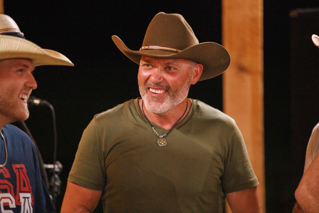 Steve Mcbee in a green shirt and brown cowboy hat, smiling with Cole Mcbee