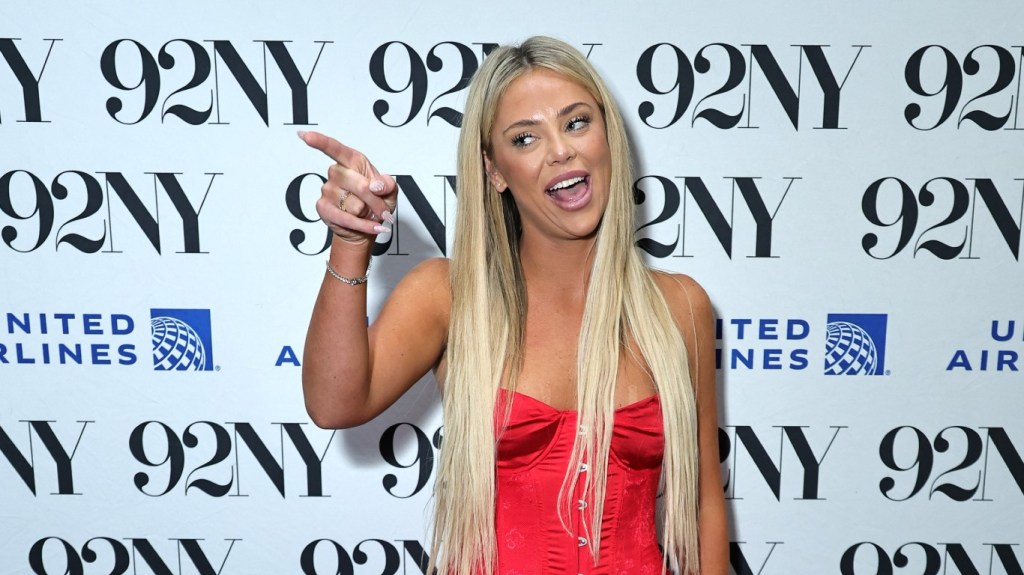 Liv Walker at 92NY wearing a red dress and pointing her finger
