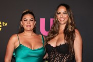 Brittany Cartwright in a green dress posing at an Us Weekly event with Kristen Doute, who is wearing a black dress