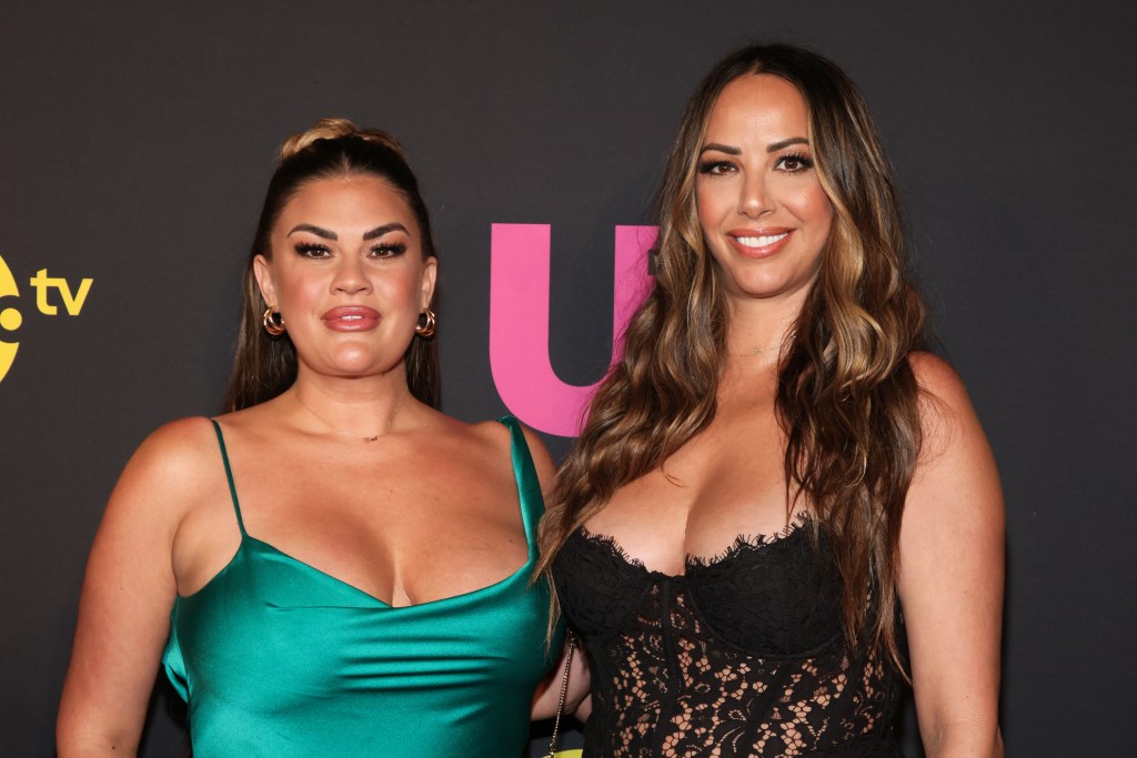 Brittany Cartwright in a green dress posing at an Us Weekly event with Kristen Doute, who is wearing a black dress