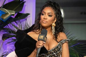 Porsha Williams in a black and silver dress, holding a black microphone