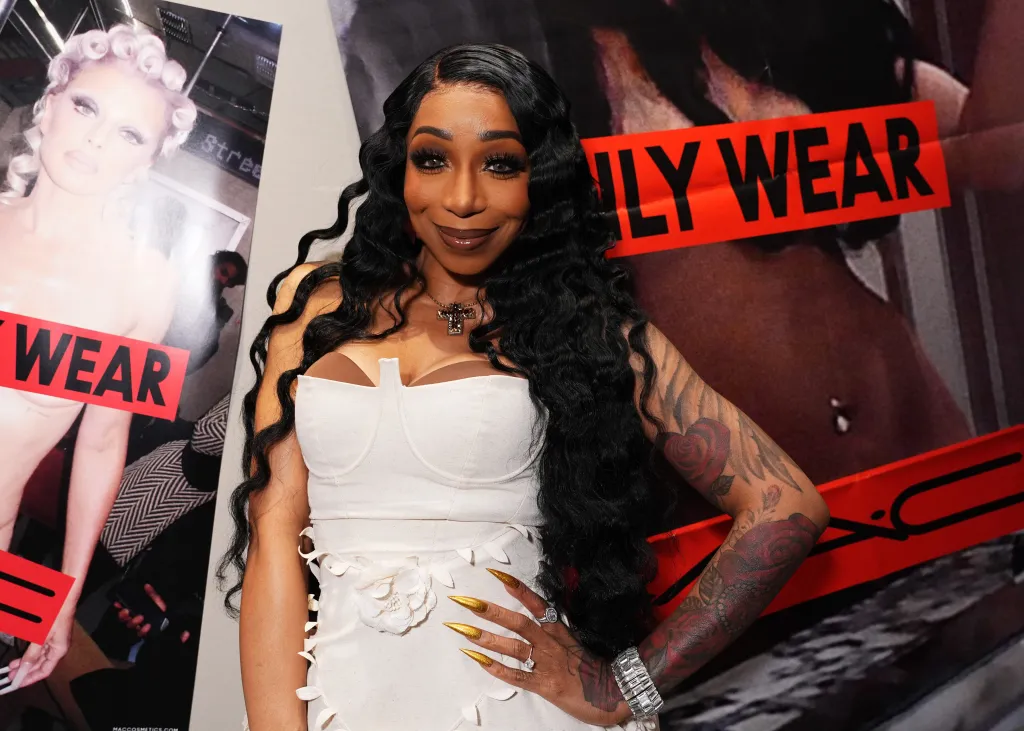 Tiffany Pollard in a white dress posing at a MAC event