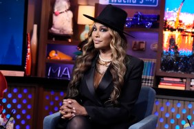 Cynthia Bailey on Watch What Happens Live wearing a black suit and a fedora