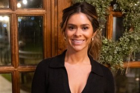 Taylor Frankie Paul in a black dress posing in front of a wreath