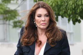 Lisa Vanderpump exiting a vehicle wearing a blue blazer and white top