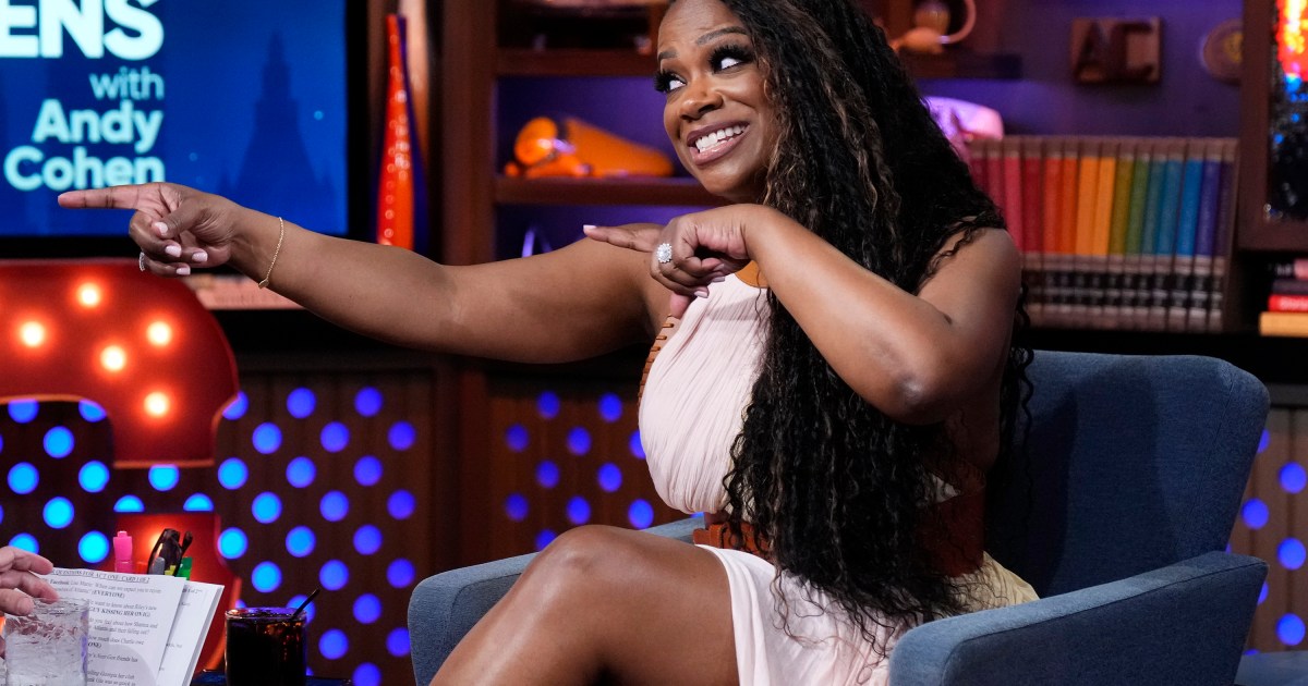 Kandi Burruss on Watch What Happens Live, pointing both hands