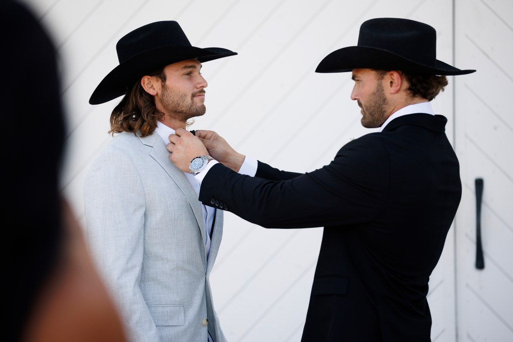 Jesse McBee on his wedding day getting his tie straightened by Steven McBee Jr