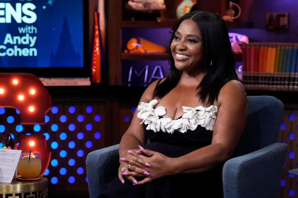 Sherri Shepherd in a black and white dress, smiling on Watch What Happens Live