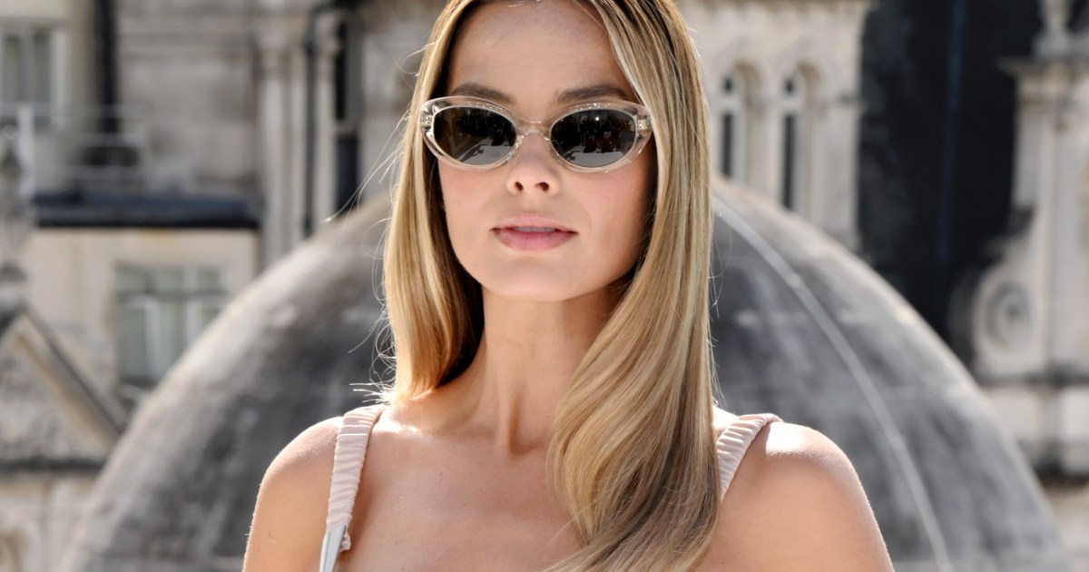 Margot Robbie Stuns in Nude Pink Bra Top & Slit Skirt in London