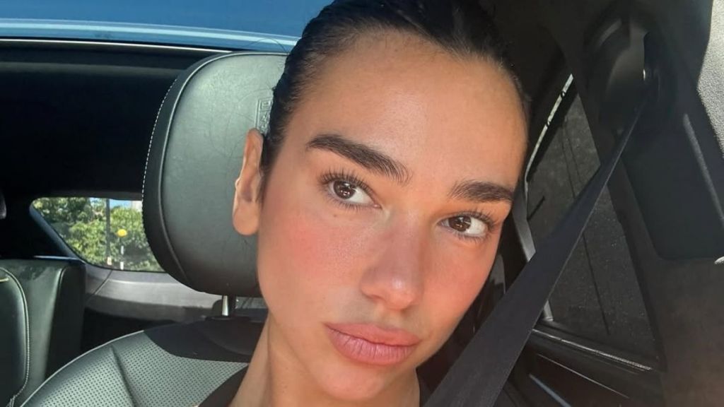 Dua Lipa Poses in White Backless Dress & Fans Can't Get Enough