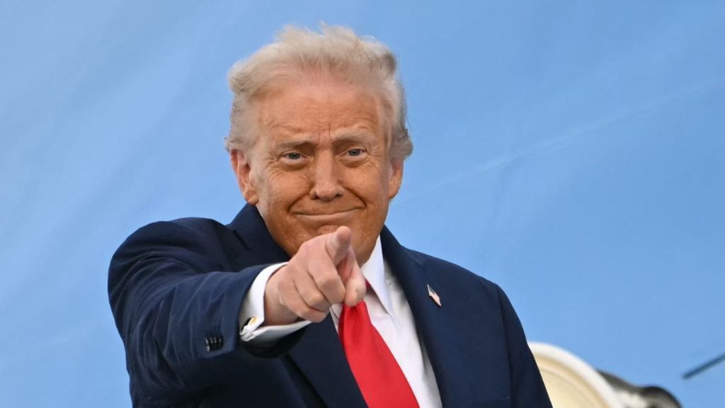 US President Donald Trump gestures as he and US First Lady Melania Trump (unseen) board Air Force One at Stansted Airport, in Stansted, north of London, on September 18, 2025, to leave at the end of the US President's second State Visit.