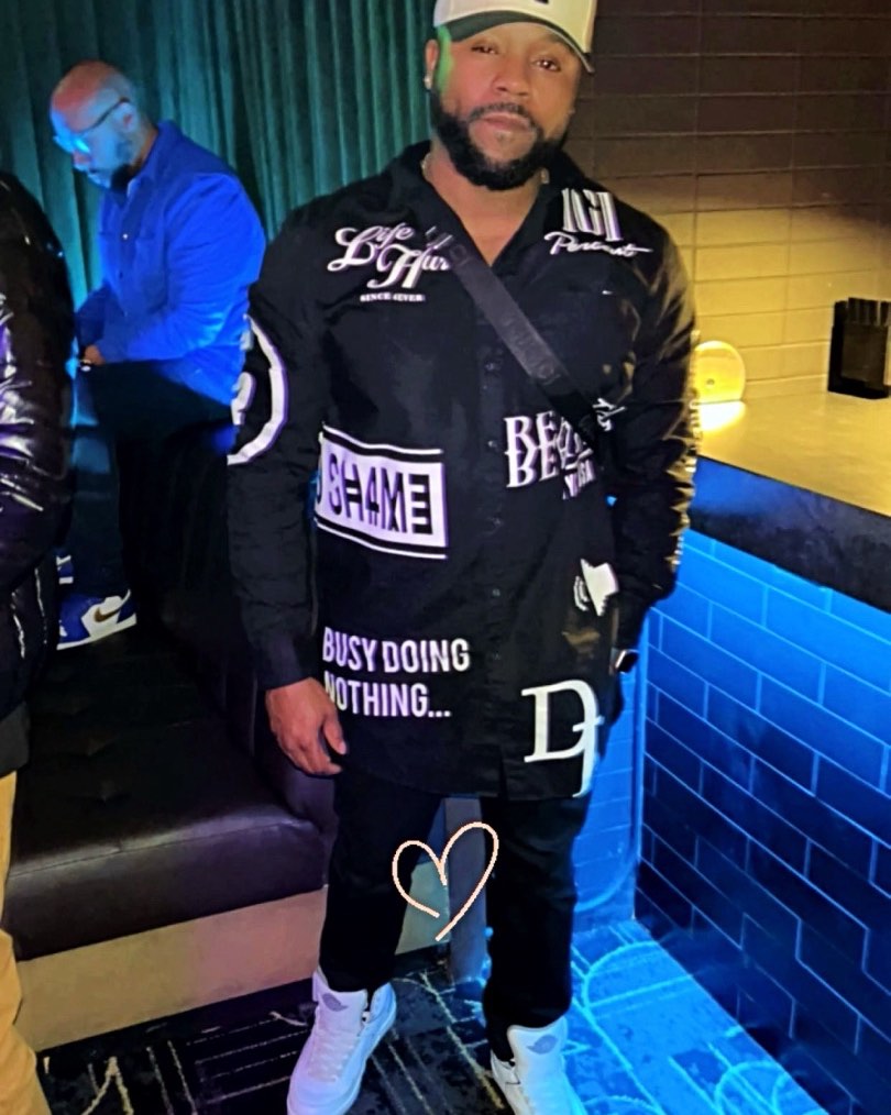 Joshua Allen in black jeans and a black moto jacket with white graphics
