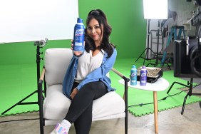 Nicole "Snooki" Polizzi holding up a bottle of Lysol, sitting in front of a green screen