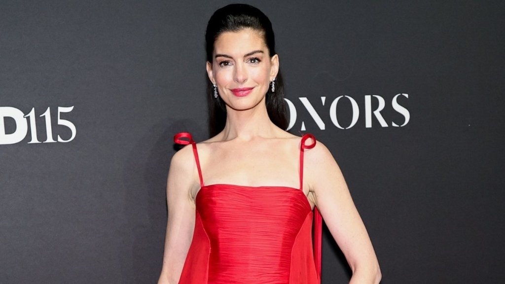 Anne Hathaway Dazzles in Red Gown at WWD Honors