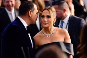 Jennifer Lopez at the Screen Actors Guild awards, looking up as Alex Rodriguez whispers in her ear