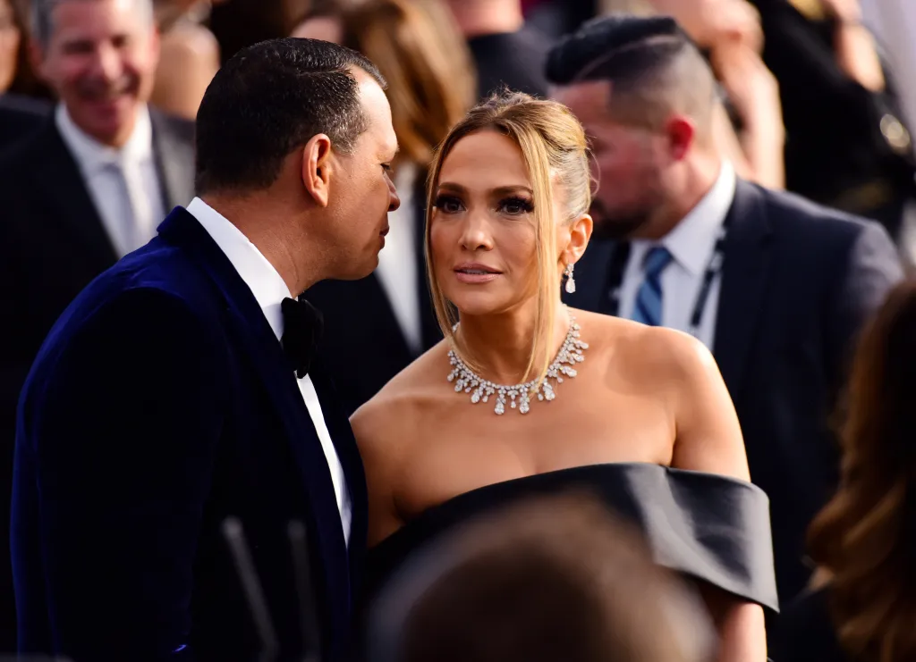 Jennifer Lopez at the Screen Actors Guild awards, looking up as Alex Rodriguez whispers in her ear