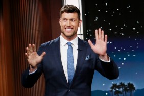 Clayton Echard in a blue suit waving his hands on Jimmy Kimmel Live