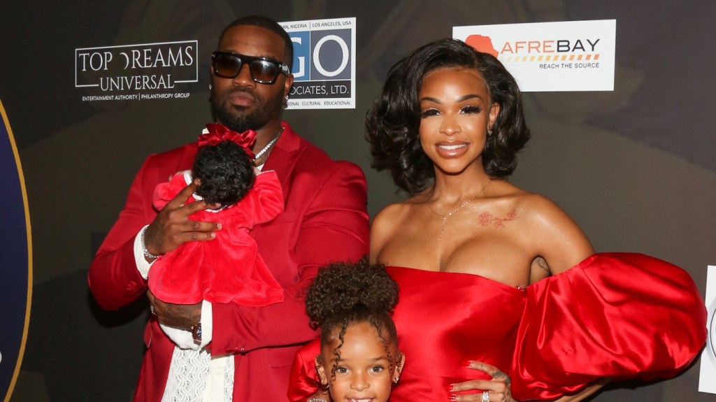 Masika Kalysha and her family on a red carpet, dressed in red