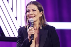 Julia Lemigova speaking into a microphone on stage at BravoCon 2023
