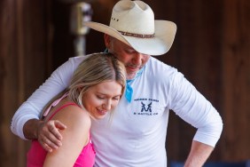 Steve McBee in a cowboy hat hugging a girl in pink