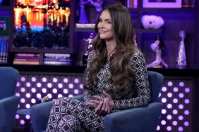 Lala Kent in a patterned jumpsuit, sitting with her legs crossed on Watch What Happens Live