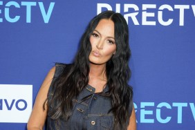 Lisa Barlow in a denim vest making a kissy face