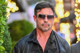 Aaron Phypers walking down a sidewalk in black shades and a leather jacket