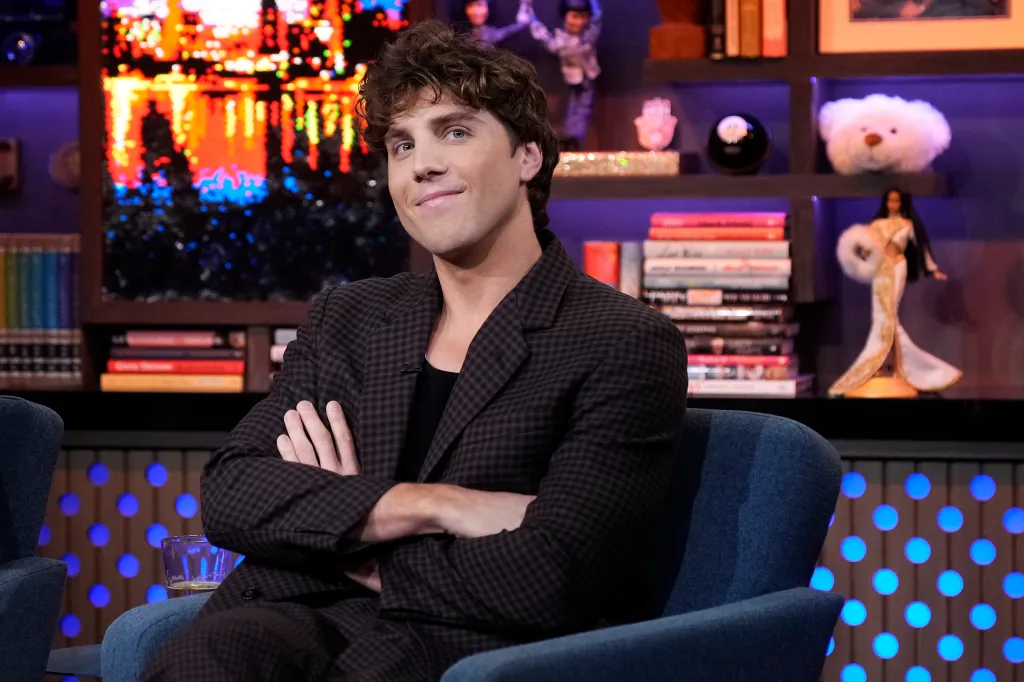 Lukas Gage with his arms crossed sitting on Watch What Happens Live