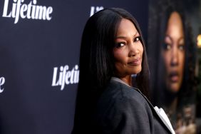 Garcelle Beauvais in a black blazer doing an over the shoulder pose at a Lifetime movie premiere