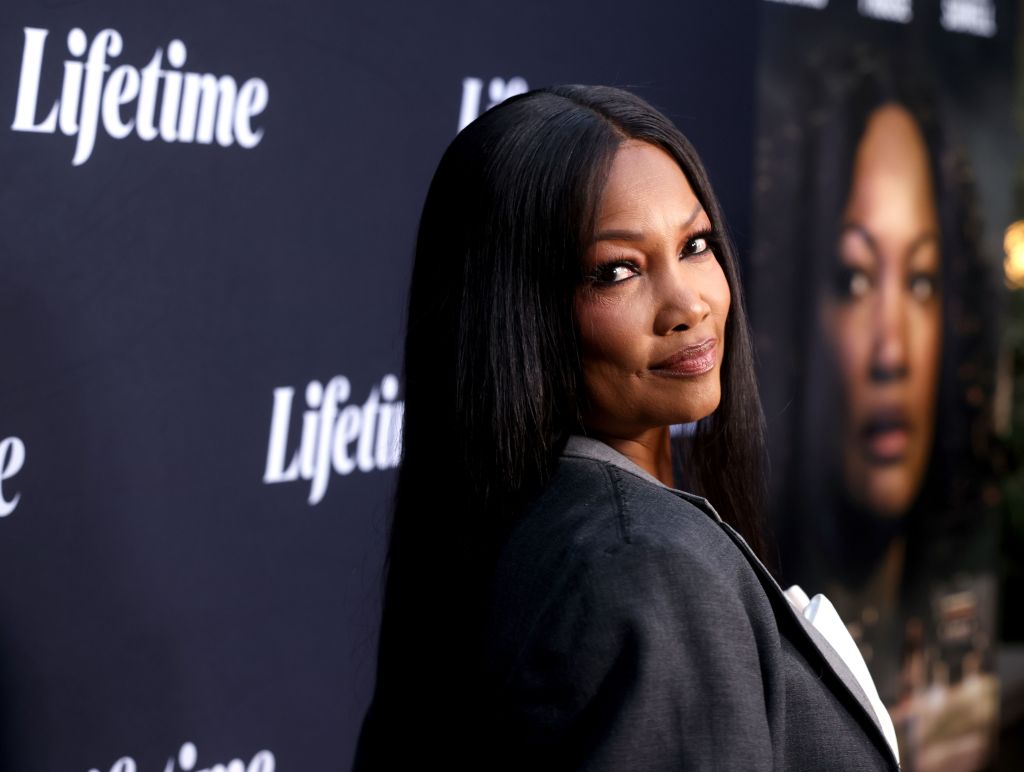 Garcelle Beauvais in a black blazer doing an over the shoulder pose at a Lifetime movie premiere
