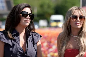 Emily Simpson in a black top standing with Tamra Judge, in a red top on Real Housewives of Orange County Season 19