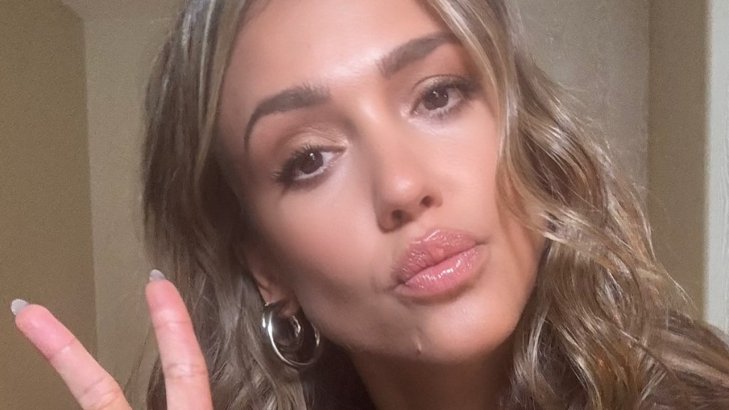 Jessica Alba Pouts As She Poses in Bold Neckline Dress