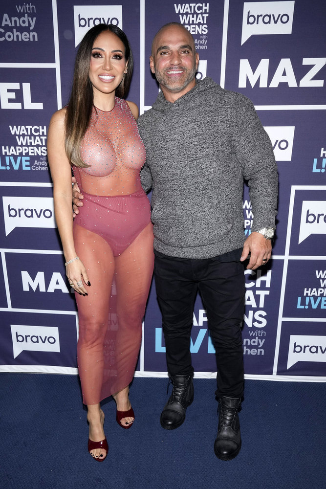 Melissa Gorga in a sheer pink dress with Joe Gorga in a grey sweater backstage at Watch What Happens Live