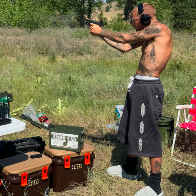 Justin Bieber shooting guns in his slippers