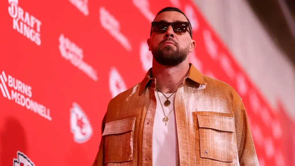 Travis Kelce Pulled Up in Showgirl Orange Look Ahead of Chiefs Game
