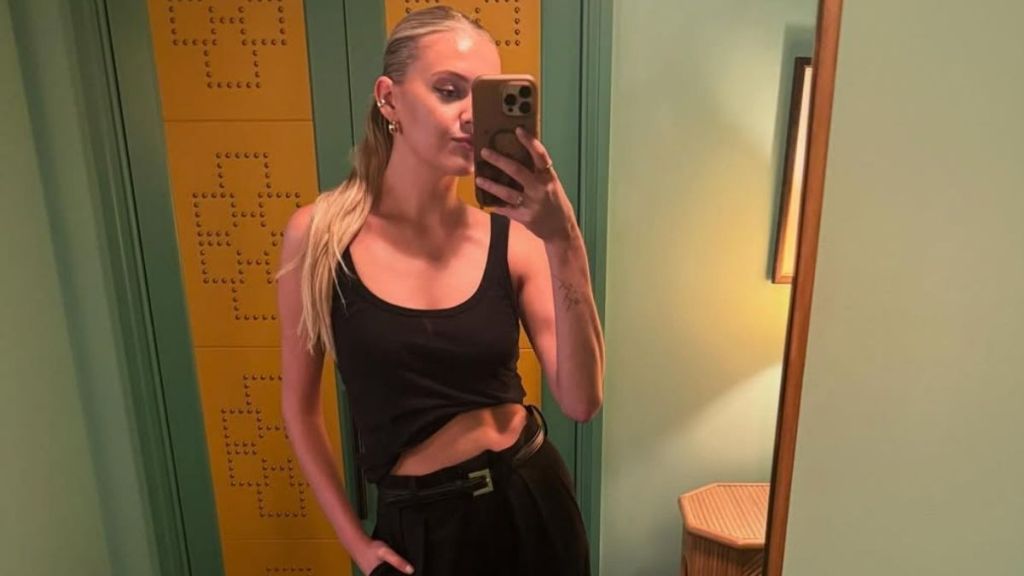 Kelsea Ballerini Poses in Large Hoodie & Tiny Shorts for Photos