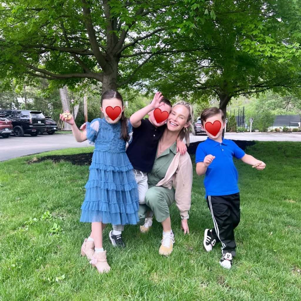 Meghan King with her three kids, their faces obscured by a red heart emoji