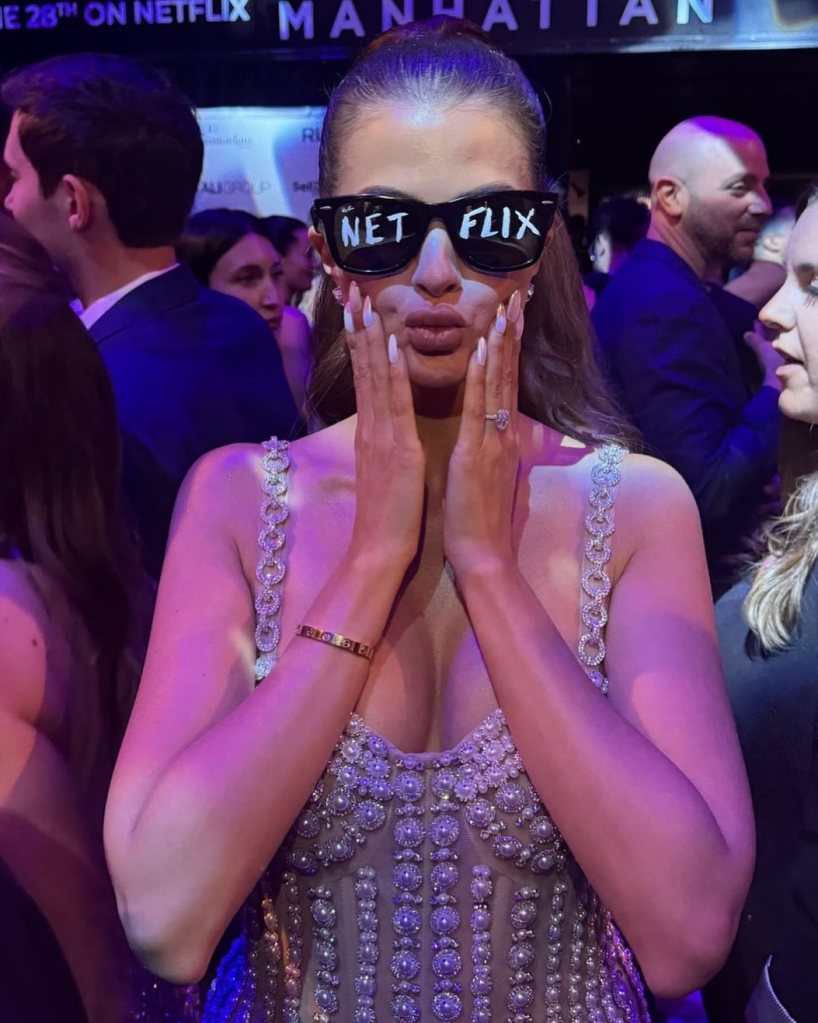 Jessica Markowsi wearing Netflix sunglasses and posing with her hands on her face