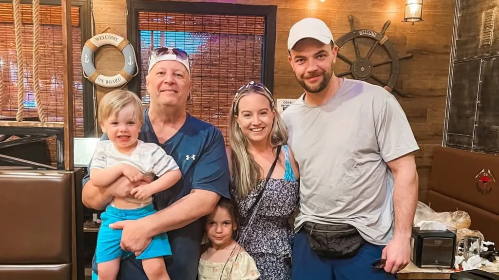 Chuck Potthast, Elizabeth Castravet, and Andrei Castravet posing with their children