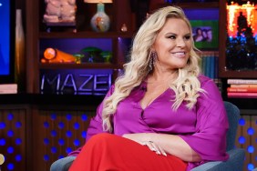 A smiling Heather Gay on Watch What Happens Live, wearing a purple blouse and red pants
