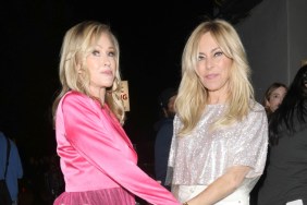 Kathy Hilton in a pink dress, grabbing the hand of Sutton Stracke