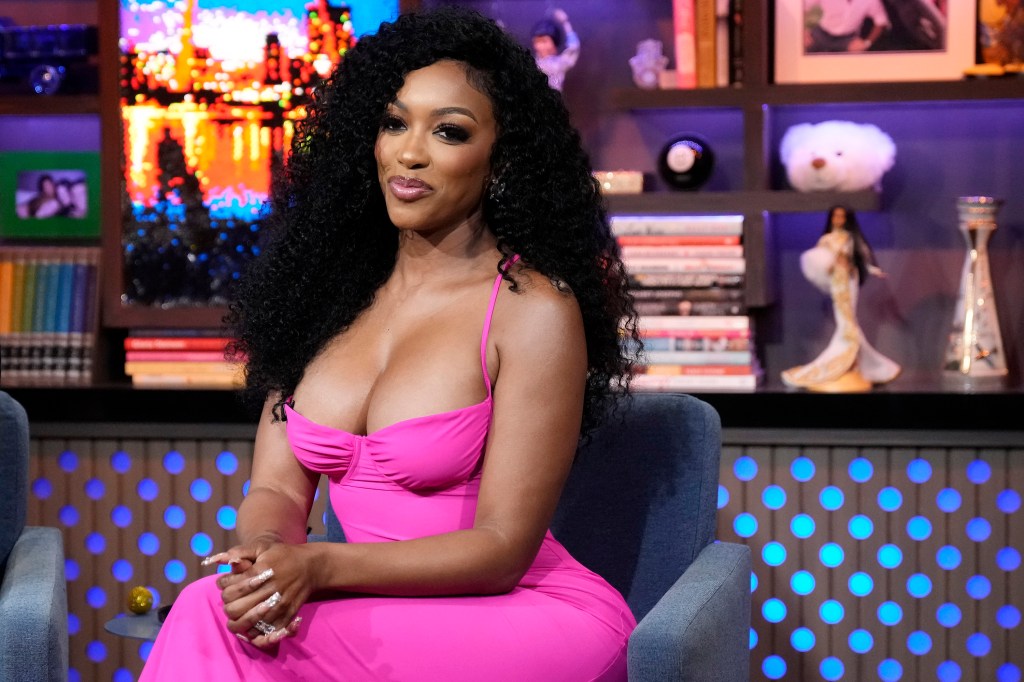 Porsha Williams in a pink dress sitting as a guest on Watch Watch Happens Live