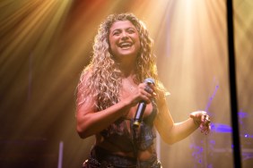 Antigoni Buxton on stage with a microphone in her hand