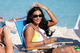 Monica Garcia sitting on the beach with a tiara